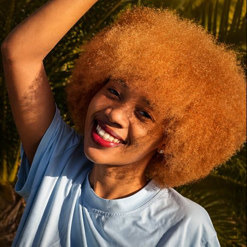 Radiant smile framed by a beautiful natural afro